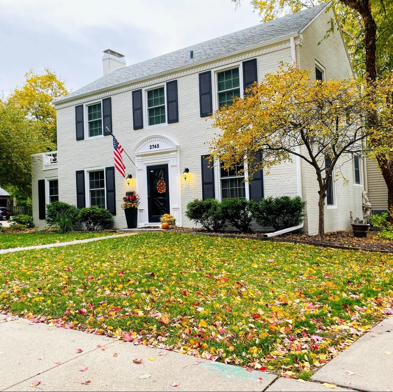 White two story home with contrasting shutters